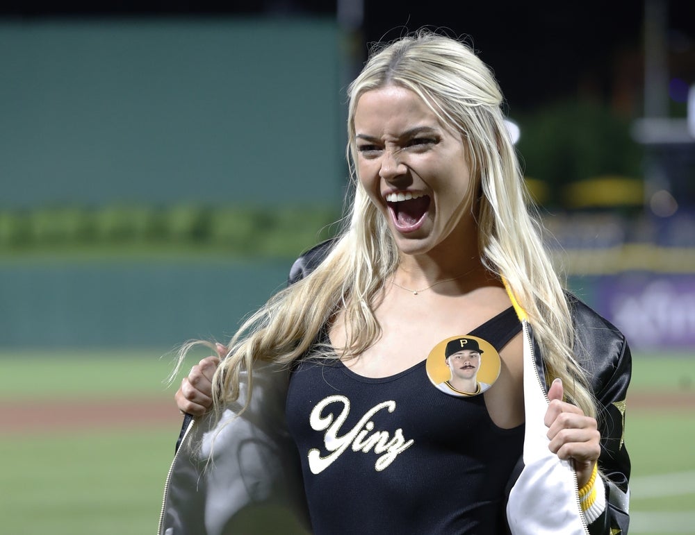 May 11, 2024; Pittsburgh, Pennsylvania, USA; Louisiana State University gymnast Olivia Dunn reacts on the field after her boyfriend Pittsburgh Pirates starting pitcher Paul Skenes (not pictured) made his major league debut against the Chicago Cubs at PNC Park. The Pirates won 10-8. Mandatory Credit: Charles LeClaire-Imagn Images