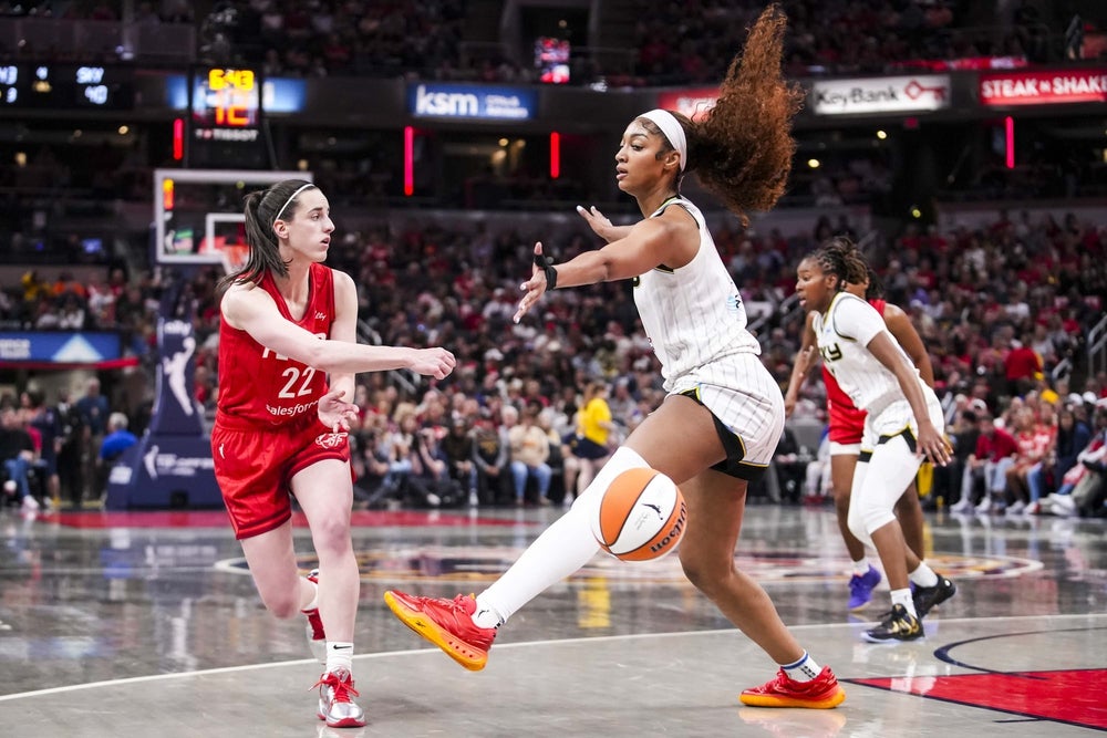 May 17, 2025; Indianapolis, IN, USA; Indiana Fever guard Caitlin Clark (22) passes around Chicago Sky forward Angel Reese (5) on Saturday, May 17, 2025, during a game between the Indiana Fever and the Chicago Sky at Gainbridge Fieldhouse in Indianapolis. The Indiana Fever defeated the Chicago Sky, 93-58.Mandatory Credit: Grace Smith-IndyStar via Imagn Images
