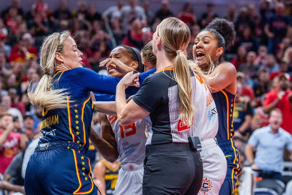 Jun 17, 2025; Indianapolis, Indiana, USA; Indiana Fever guard Sophie Cunningham (8) and Connecticut Sun guard Jacy Sheldon (4) get into a fight in the second half at Gainbridge Fieldhouse. Mandatory Credit: Trevor Ruszkowski-Imagn Images