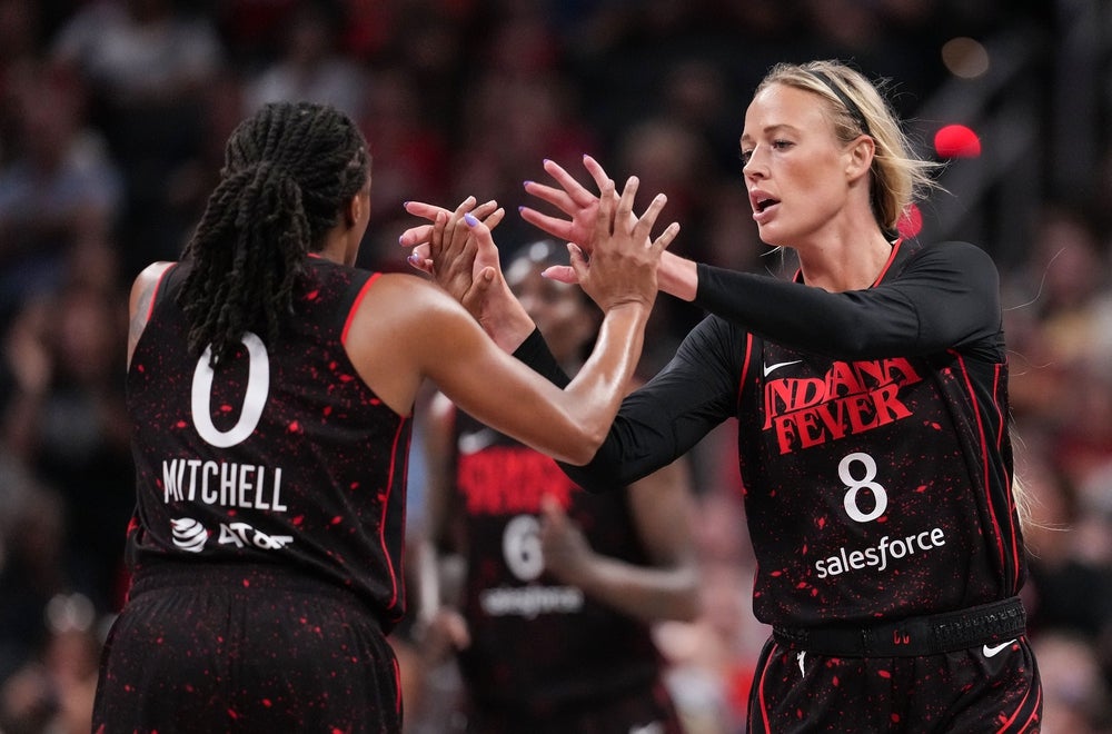 Indiana Fever guard Sophie Cunningham (8) high-fives Indiana Fever guard Kelsey Mitchell (0) on Tuesday, Aug. 12, 2025, during the game at Gainbridge Fieldhouse in Indianapolis.