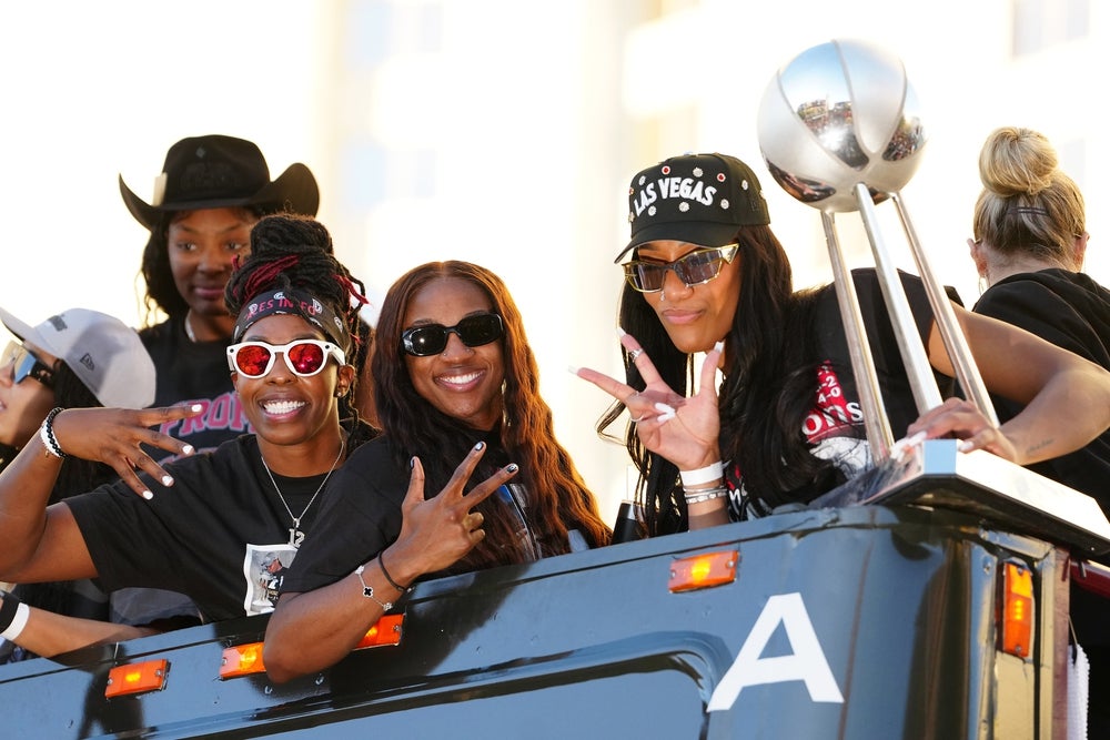 Oct 17, 2025; Las Vegas, NV, USA; Las Vegas Aces guard Chelsea Gray (12), guard Jackie Young (0), and center A'Ja Wilson (22) pose for a photo during the 2025 WNBA Championship parade at Toshiba Plaza. Mandatory Credit: Stephen R. Sylvanie-Imagn Images