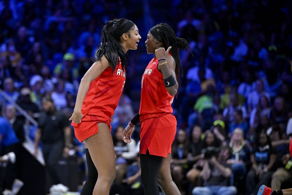May 12, 2026; Arlington, Texas, USA; Atlanta Dream forward Angel Reese (5) and Atlanta Dream guard Rhyne Howard (10) celebrate during the game between the Wings and the Dream at College Park Center. Mandatory Credit: Jerome Miron-Imagn Images