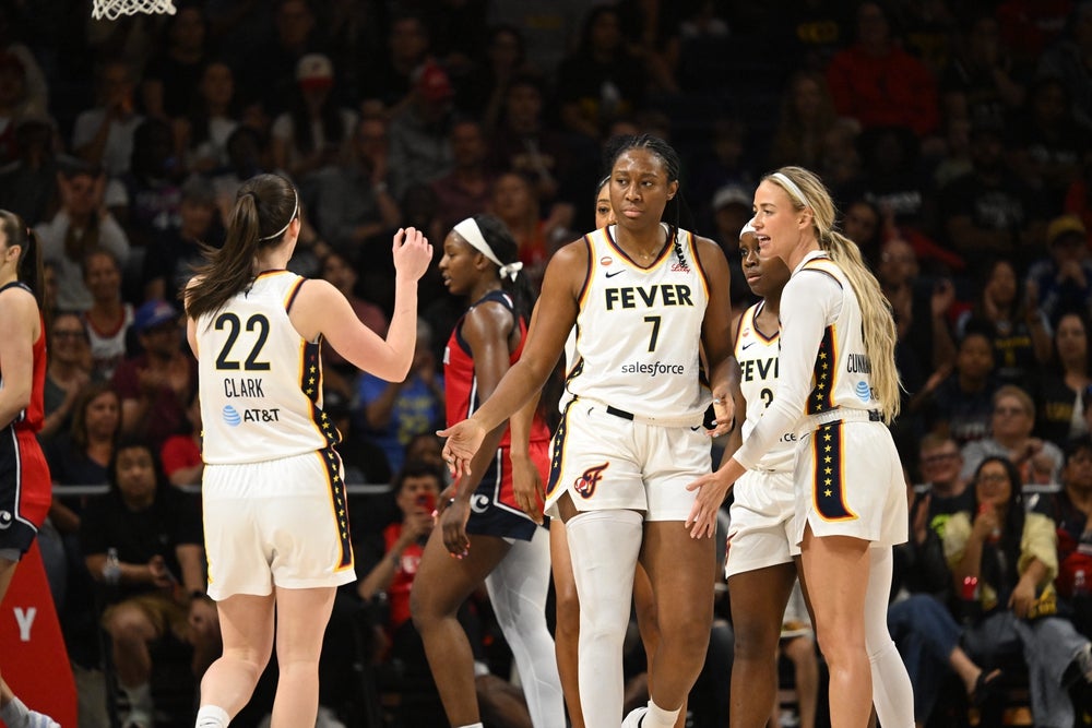 Jun 8, 2026; Washington, District of Columbia, USA; Indiana Fever center-forward Aliyah Boston (7) celebrates a play with guard Caitlin Clark (22) and guard Sophie Cunningham (8) against the Washington Mystics during the first quarter at CareFirst Arena. Mandatory Credit: Rafael Suanes-Imagn Images