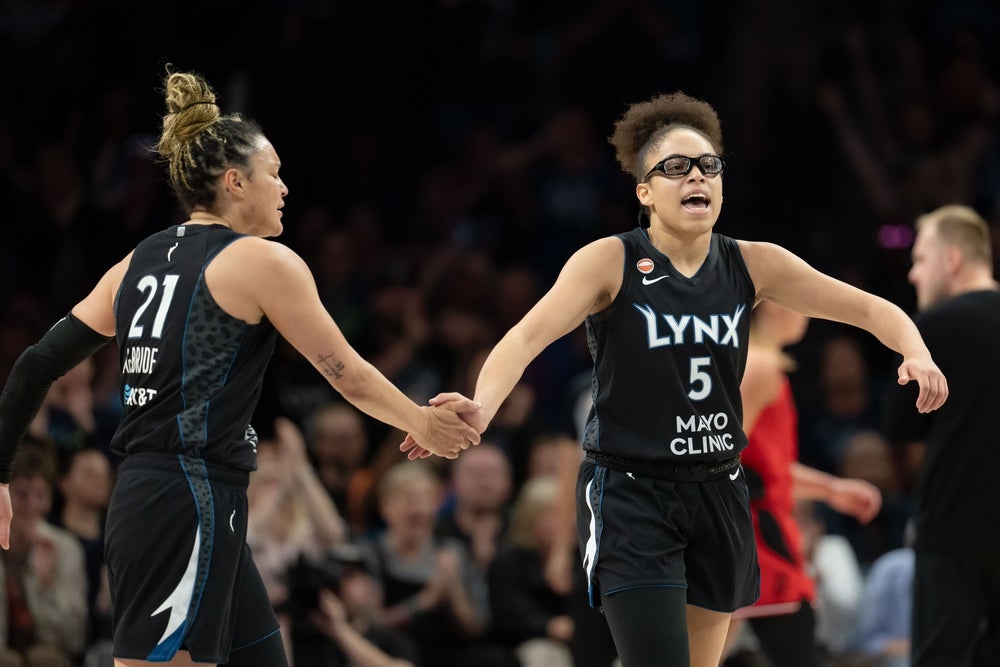 Jun 15, 2026; Minneapolis, Minnesota, USA; Minnesota Lynx guard Olivia Miles (5) celebrates with Minnesota Lynx guard Kayla McBride (21) after making a shot against the Portland Fire in the second half at Target Center. Mandatory Credit: Jesse Johnson-Imagn Images
