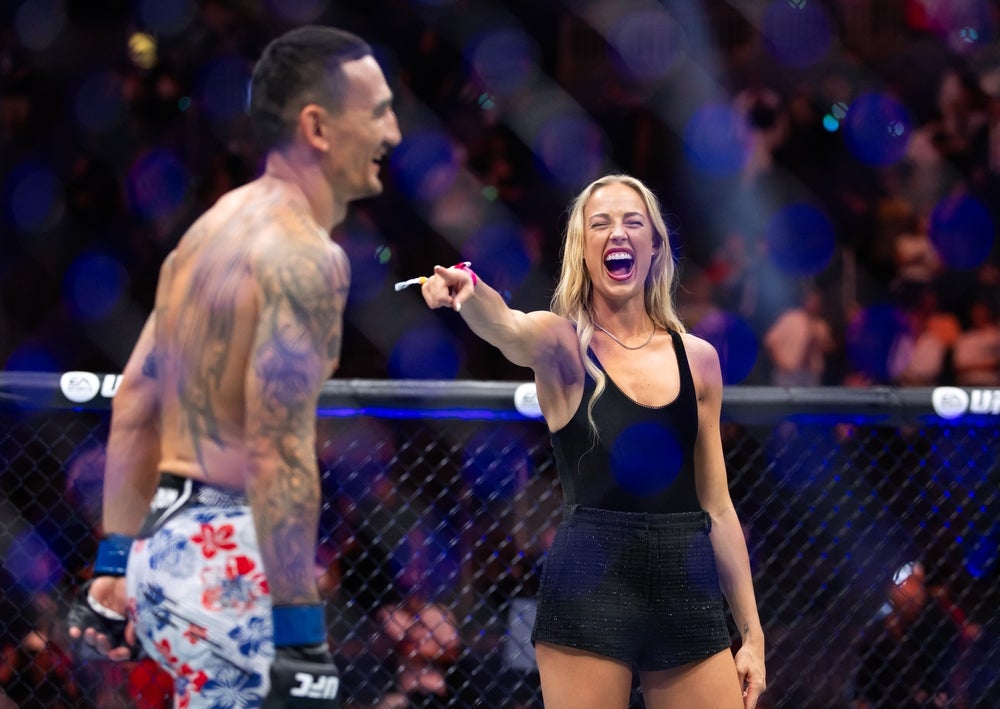 Jul 11, 2026; Las Vegas, Nevada, USA; Indiana Fever guard Sophie Cunningham (right) laughs as she points at Max Holloway following UFC 329 at T-Mobile Arena. Mandatory Credit: Mark J. Rebilas-Imagn Images