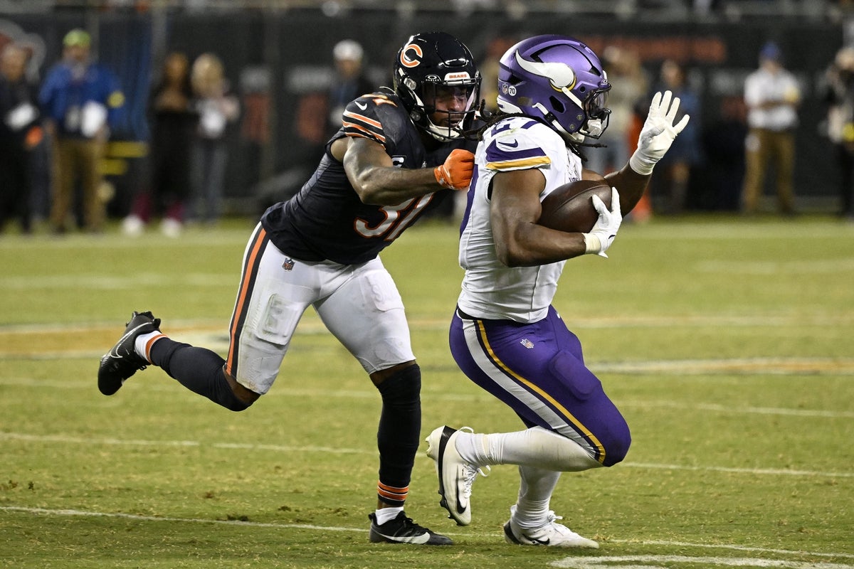 Sep 8, 2025; Chicago, Illinois, USA; Minnesota Vikings running back Jordan Mason (27) rushes the ball against Chicago Bears safety Kevin Byard III (31) during the second half at Soldier Field. Mandatory Credit: Matt Marton-Imagn Images