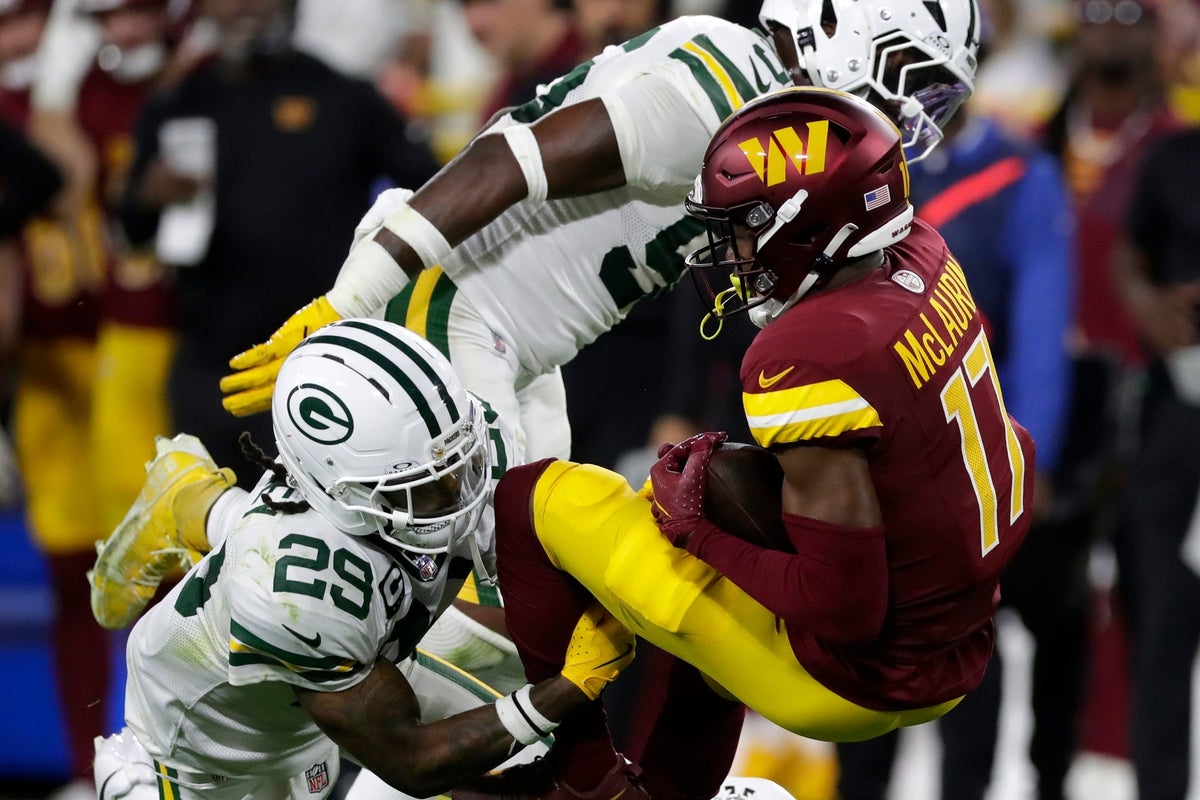 Washington Commanders wide receiver Terry McLaurin (17) is tackled by Green Bay Packers safety Xavier McKinney (29) during a game on Sept. 11, 2025, at Lambeau Field in Green Bay, Wis. The Packers defeated the Commanders 27-18.