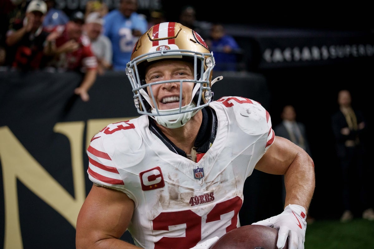 Sep 14, 2025; New Orleans, Louisiana, USA;  San Francisco 49ers running back Christian McCaffrey (23) reacts after catching a touchdown against the New Orleans Saints during the second quarter at Caesars Superdome. Mandatory Credit: Matthew Hinton-Imagn Images