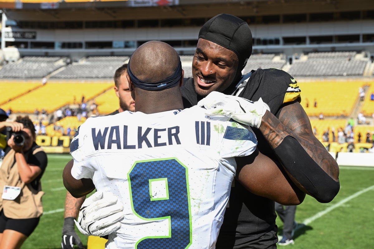 Sep 14, 2025; Pittsburgh, Pennsylvania, USA; Pittsburgh Steelers wide receiver DK Metcalf (4) greets Seattle Seahawks running back Kenneth Walker III (9) ollowing their game at Acrisure Stadium. Mandatory Credit: Barry Reeger-Imagn Images