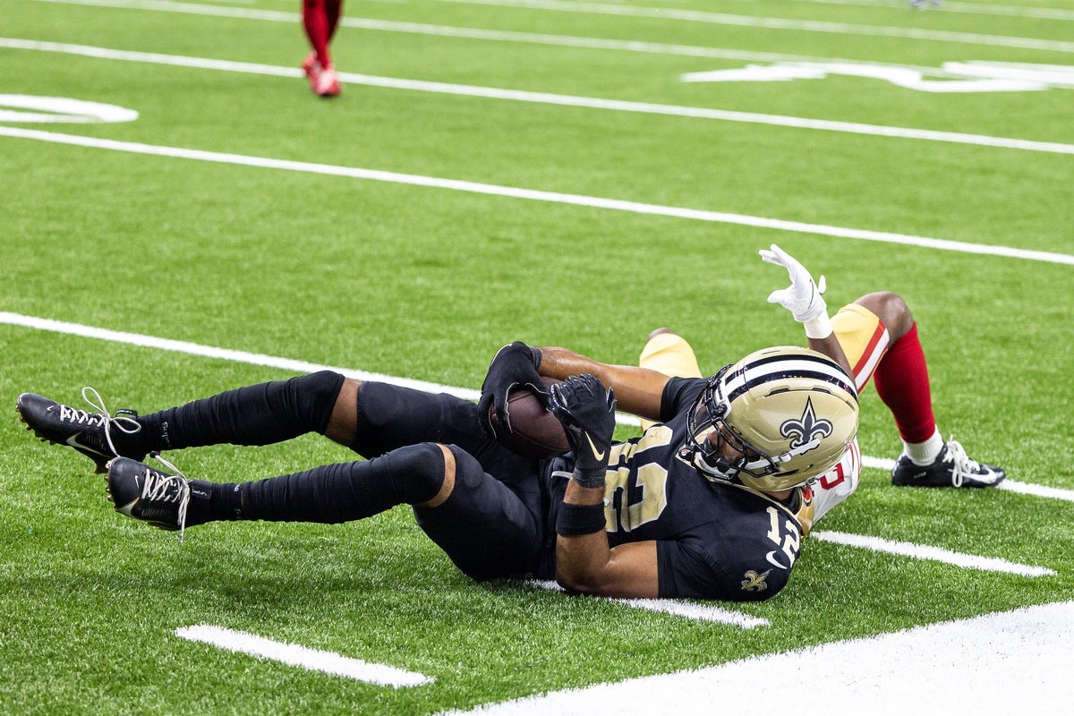 Sep 14, 2025; New Orleans, Louisiana, USA;  New Orleans Saints wide receiver Chris Olave (12) catches a pass against San Francisco 49ers cornerback Upton Stout (20) during the second half at Caesars Superdome. Mandatory Credit: Stephen Lew-Imagn Images