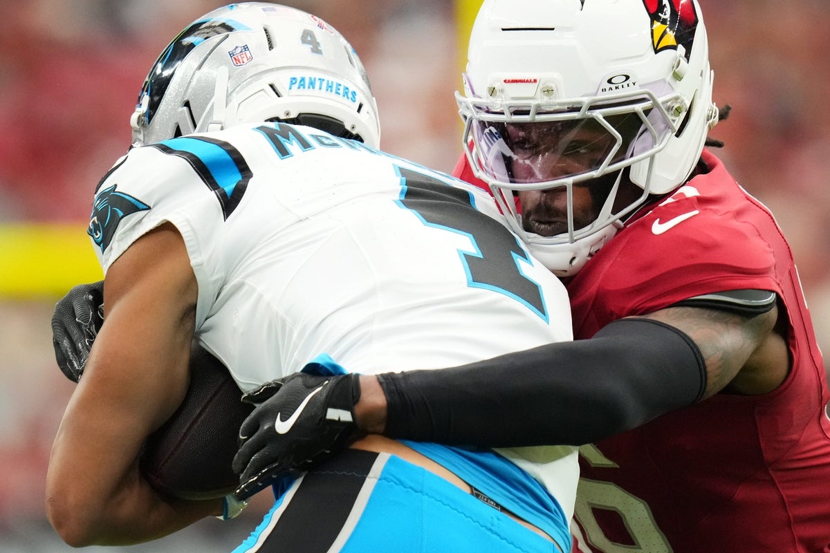 Arizona Cardinals cornerback Max Melton (16) tackles Carolina Panthers receiver Tetairoa McMillan (4) at State Farm Stadium on Sept 14, 2025.