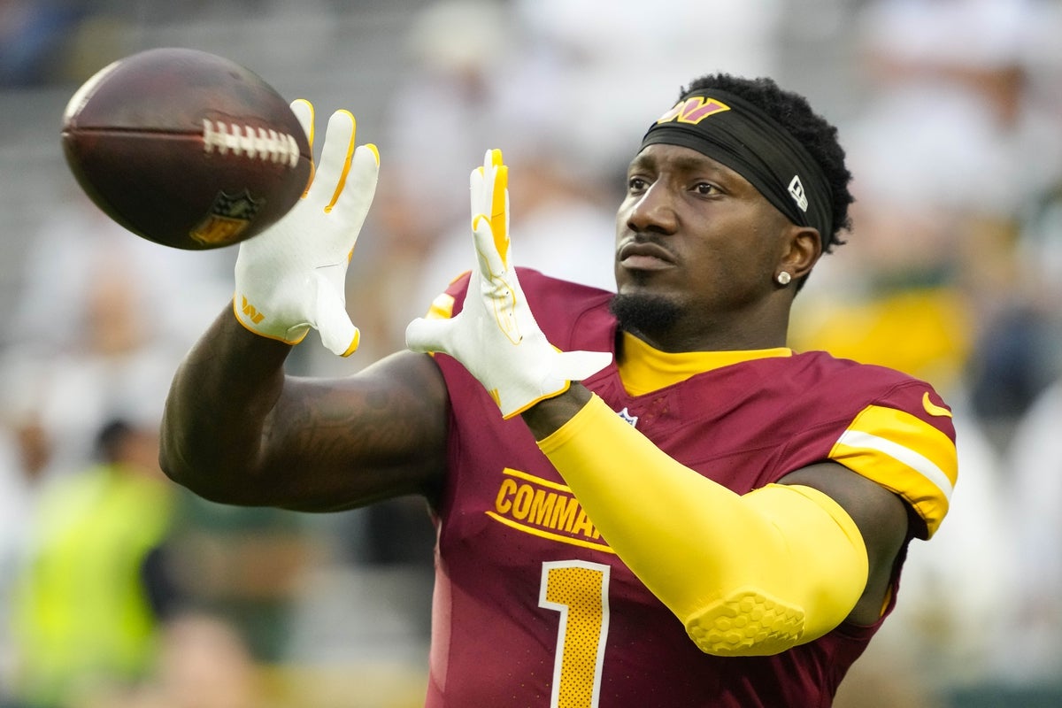 Sep 11, 2025; Green Bay, Wisconsin, USA; Washington Commanders wide receiver Deebo Samuel Sr. (1) catches a pass during warmups prior to the game against the Green Bay Packers at Lambeau Field. Mandatory Credit: Jeff Hanisch-Imagn Images