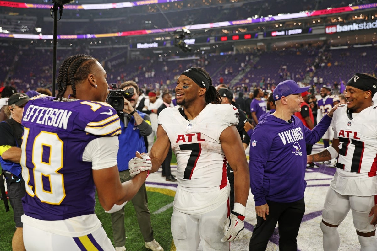 Sep 14, 2025; Minneapolis, Minnesota, USA; Minnesota Vikings wide receiver Justin Jefferson (18) and Atlanta Falcons running back Bijan Robinson (7) react after the game at U.S. Bank Stadium. Mandatory Credit: Matt Krohn-Imagn Images