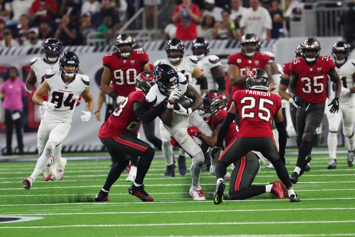 Sep 15, 2025; Houston, Texas, USA; Houston Texans wide receiver Nico Collins (12) makes a catch for a first down as Tampa Bay Buccaneers cornerback Zyon McCollum (27) defends at NRG Stadium. Mandatory Credit: Thomas Shea-Imagn Images