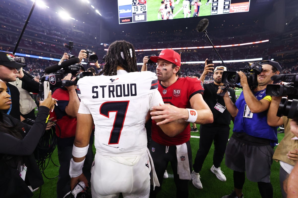 Sep 15, 2025; Houston, Texas, USA; Tampa Bay Buccaneers quarterback Baker Mayfield (6) and Houston Texans quarterback C.J. Stroud (7) meet on the field after the game at NRG Stadium. Mandatory Credit: Troy Taormina-Imagn Images