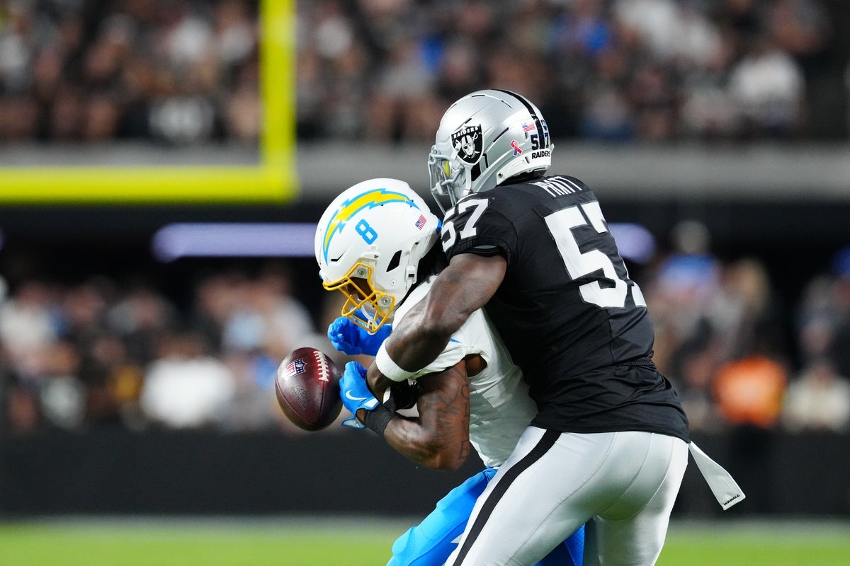 Sep 15, 2025; Paradise, Nevada, USA; Los Angeles Chargers running back Omarion Hampton (8) drops a pass as Las Vegas Raiders linebacker Germaine Pratt (57) defends during the first quarter at Allegiant Stadium. Mandatory Credit: Stephen R. Sylvanie -Imagn Images