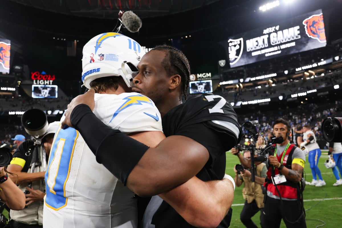 Sep 15, 2025; Paradise, Nevada, USA; Las Vegas Raiders quarterback Geno Smith (7) greets Los Angeles Chargers quarterback Justin Herbert (10) after the game at Allegiant Stadium. Mandatory Credit: Kiyoshi Mio-Imagn Images
