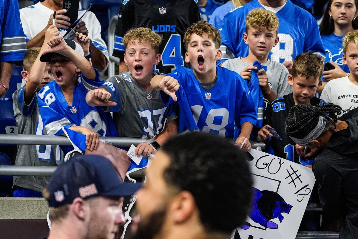 Young Detroit Lions fans boo Chicago Bears quarterback Caleb Williams during warmups at Ford Field in Detroit on Sunday, Sept. 14, 2025.