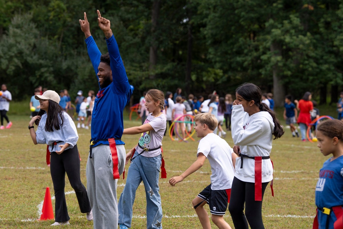 Sep 16, 2025; Mahwah, NJ, USA; New York Giants player Tyrone Tracy Jr. with students at the Joyce Kilmer School as part of a PLAY:60 event which encourages 60 minutes of active play each day.