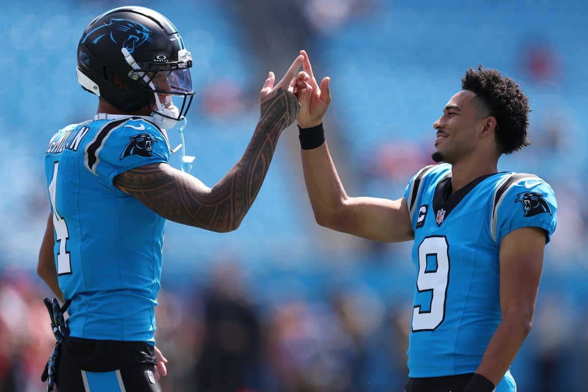 Sep 21, 2025; Charlotte, North Carolina, USA; Carolina Panthers quarterback Bryce Young (9) and wide receiver Tetairoa McMillan (4) high five before a game against the Carolina Panthers at Bank of America Stadium. Mandatory Credit: Cory Knowlton-Imagn Images