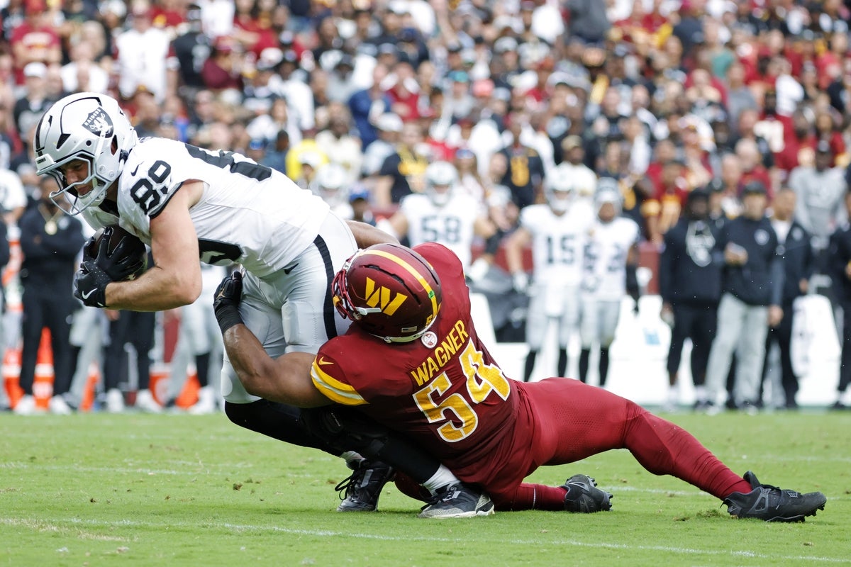 Sep 21, 2025; Landover, Maryland, USA; Las Vegas Raiders tight end Brock Bowers (89) and Washington Commanders middle linebacker Bobby Wagner (54) collide during the second half at Northwest Stadium. Mandatory Credit: Amber Searls-Imagn Images