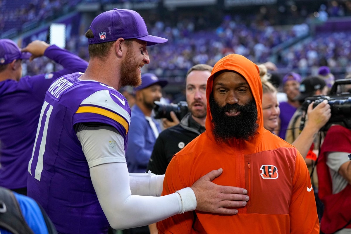 Minnesota Vikings quarterback Carson Wentz (11) and Cincinnati Bengals running back Samaje Perine (34) exchange words after the fourth quarter of the NFL Week 3 game between the Minnesota Vikings and the Cincinnati Bengals at U.S. Bank Stadium in Minneapolis on Sunday, Sept. 21, 2025. The Vikings won, 48-10.