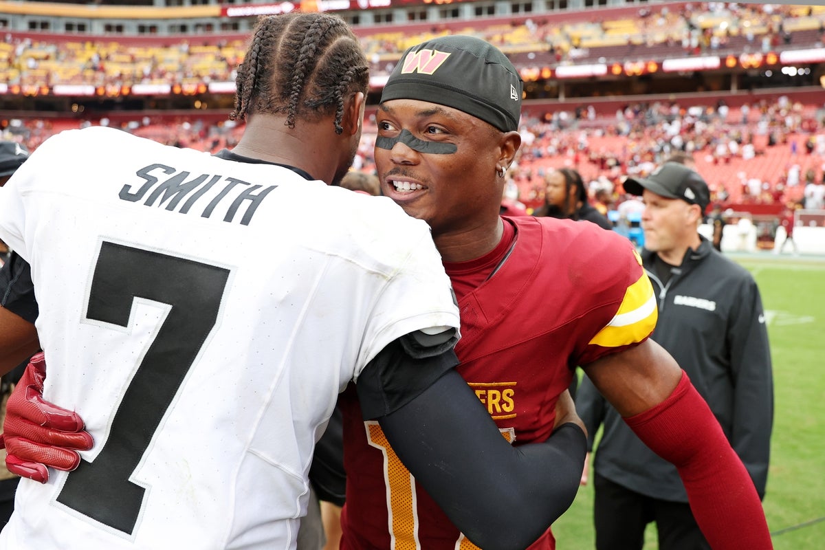Sep 21, 2025; Landover, Maryland, USA; Las Vegas Raiders quarterback Geno Smith (7) and Washington Commanders wide receiver Terry McLaurin (17) react after the game at Northwest Stadium. Mandatory Credit: Geoff Burke-Imagn Images