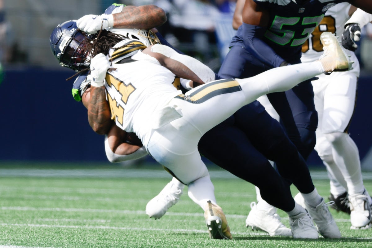 Sep 21, 2025; Seattle, Washington, USA; Seattle Seahawks defensive end Leonard Williams (99) tackles New Orleans Saints running back Alvin Kamara (41) during the second quarter at Lumen Field. Mandatory Credit: Joe Nicholson-Imagn Images