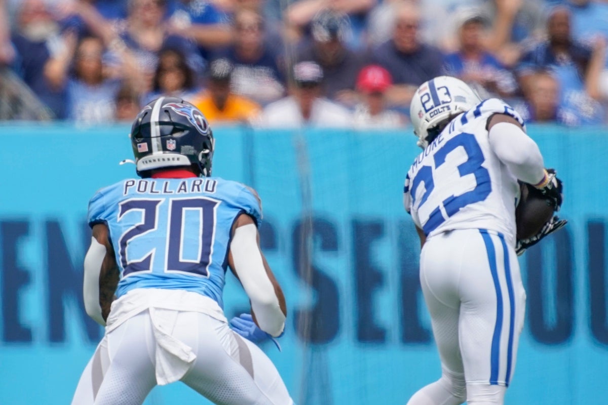 Indianapolis Colts cornerback Kenny Moore II (23) intercepts a pass intended for Tennessee Titans running back Tony Pollard (20) during the first quarter at Nissan Stadium in Nashville, Tenn., Sunday, Sept. 21, 2025.