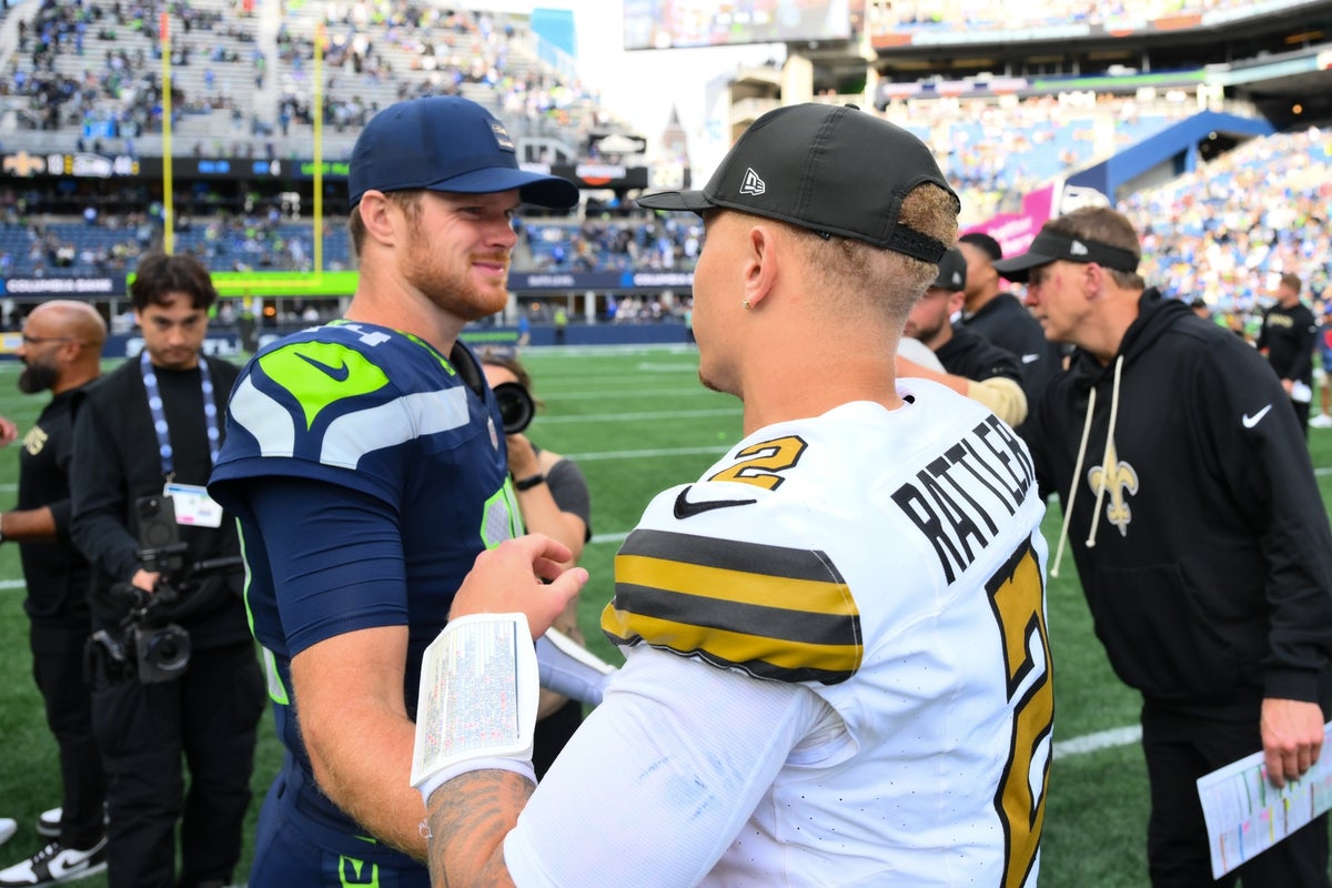 Sep 21, 2025; Seattle, Washington, USA; Seattle Seahawks quarterback Sam Darnold (14) and New Orleans Saints quarterback Spencer Rattler (2) shake hands after the game at Lumen Field. Mandatory Credit: Steven Bisig-Imagn Images