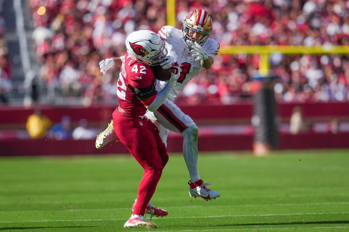 Sep 21, 2025; Santa Clara, California, USA; Arizona Cardinals safety Dadrion Taylor-Demerson (42) makes the interception in front of San Francisco 49ers wide receiver Ricky Pearsall (1) during the second half at Levi