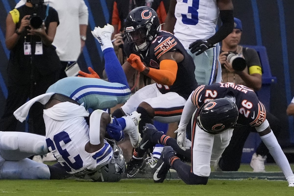 Sep 21, 2025; Chicago Bears cornerback Nahshon Wright (26) tackles Dallas Cowboys running back Javonte Williams (33) during the second half at Soldier Field. Mandatory Credit: David Banks-Imagn Images