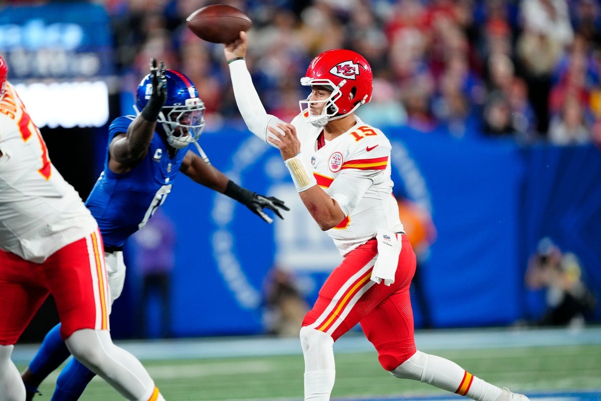 Kansas City Chiefs quarterback Patrick Mahomes (15) tries to make a pass before the Giants defense can get to him, Sunday, September 21, 2025.