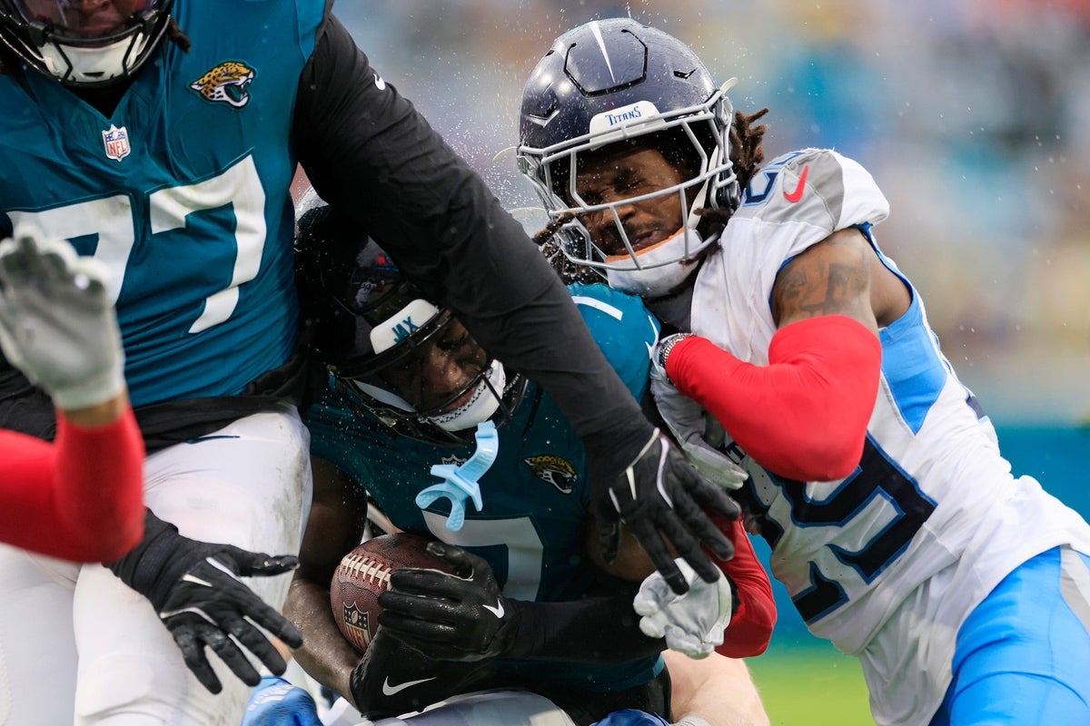 Jacksonville Jaguars wide receiver Brian Thomas Jr. (7) is tackled out of bounds by Tennessee Titans cornerback Jarvis Brownlee Jr. (29) during the second quarter of an NFL football matchup Sunday, Dec. 29, 2024 at EverBank Stadium in Jacksonville, Fla.