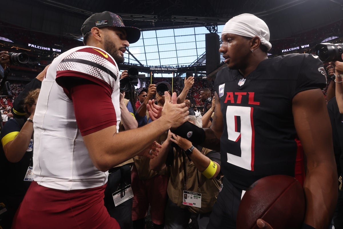 Sep 28, 2025; Atlanta, Georgia, USA; Washington Commanders quarterback Marcus Mariota (8) and Atlanta Falcons quarterback Michael Penix Jr. (9) greet each other after a game at Mercedes-Benz Stadium. Mandatory Credit: Brett Davis-Imagn Images