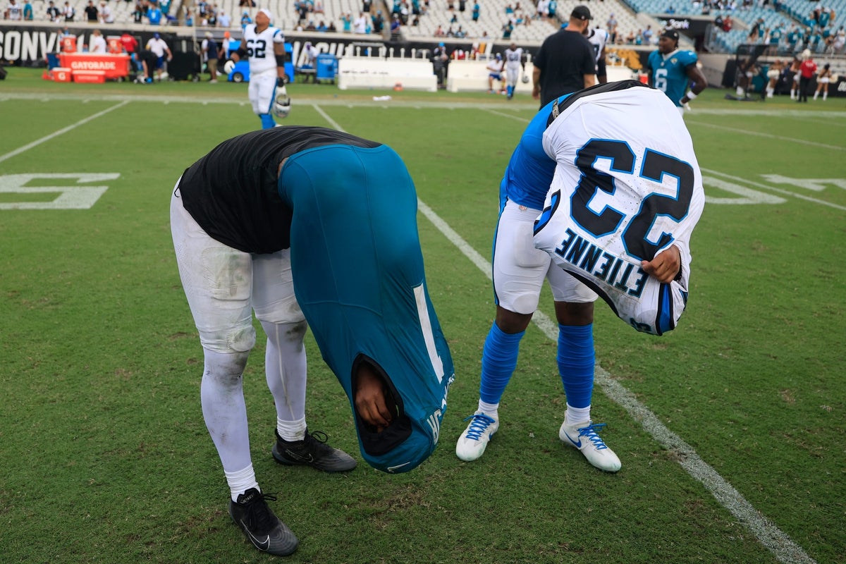 Jacksonville Jaguars running back Travis Etienne Jr. (1), left, and Carolina Panthers running back Trevor Etienne (23), both brothers, exchange jerseys after the game of an NFL football matchup at EverBank Stadium, Sunday, Sept. 7, 2025 in Jacksonville, Fla. The Jaguars defeated the Panthers 26-10.