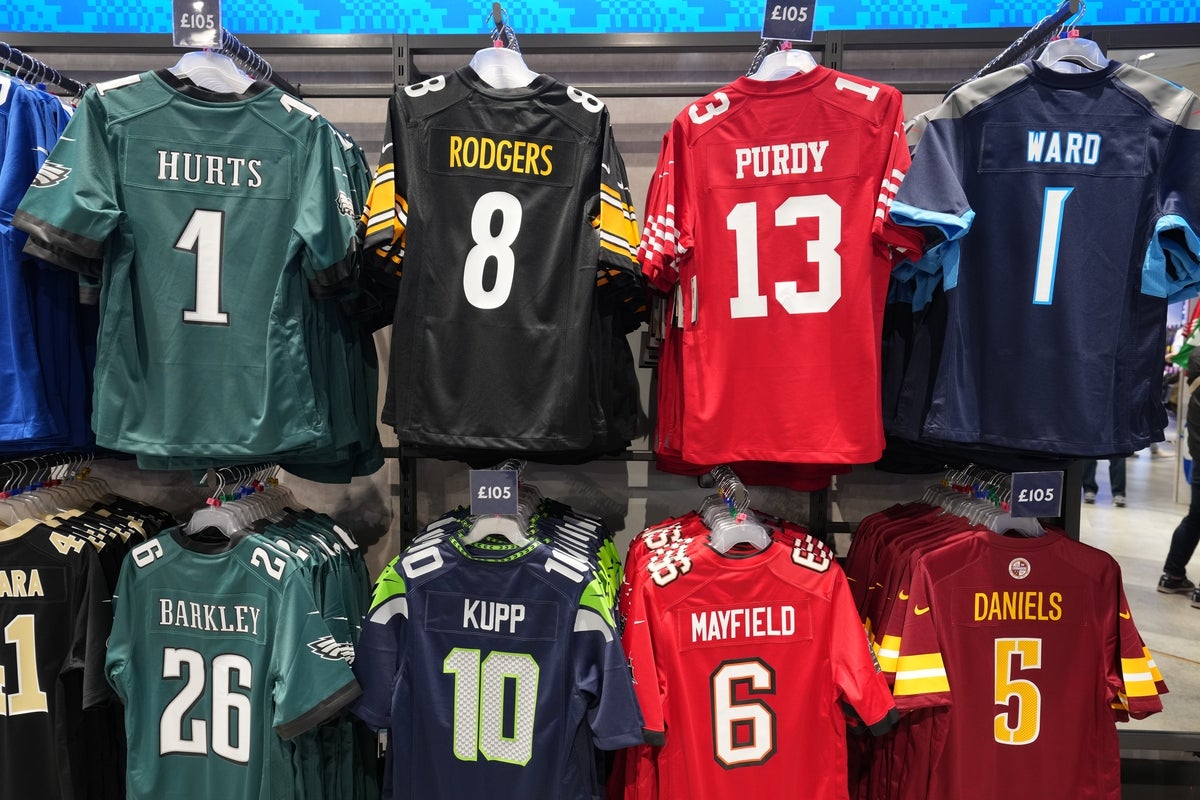 Oct 4, 2025; London, United Kingdom; The Nike jerseys of Philadelphia Eagles quarterback Jalen Hurts (1), Pittsburgh Steelers quarterback Aaron Rodgers (8), San Francisco 49ers quarterback Brock Purdy (13), Tennessee Titans quarterback Cam Ward (1), Philadelphia Eagles running back Saquon Barkley (26), Seattle Seahawks receiver Cooper Kupp (10), Tampa Bay Buccaneers quarterback Baker Mayfield (6) and Washington Commanders quarterback Jayden Daniels (5) at the NFL Shop at Tottenham Hotspur Stadium. Mandatory Credit: Kirby Lee-Imagn Images