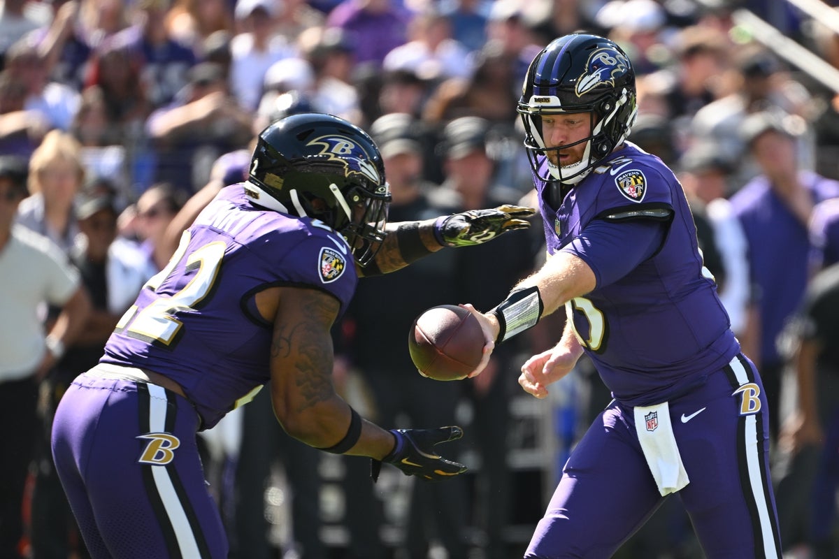 Oct 5, 2025; Baltimore, Maryland, USA; Baltimore Ravens quarterback Cooper Rush (15) hands the ball off to running back Derrick Henry (22) during the first quarter against the Houston Texans at M&T Bank Stadium. Mandatory Credit: Rafael Suanes-Imagn Images