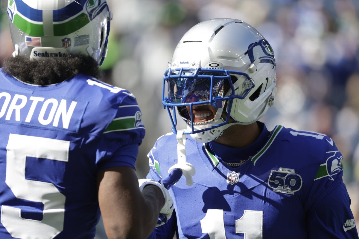 Oct 5, 2025; Seattle, Washington, USA;  Seattle Seahawks wide receiver Jaxon Smith-Njigba (11) and wide receiver Tory Horton (15) warm up prior to a game against the Tampa Bay Buccaneers at Lumen Field. Mandatory Credit: Joe Nicholson-Imagn Images