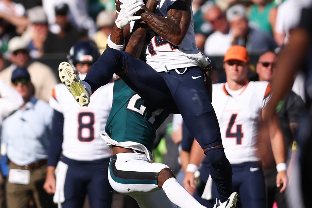 Oct 5, 2025; Philadelphia, Pennsylvania, USA; Denver Broncos wide receiver Courtland Sutton (14) makes a first down catch against Philadelphia Eagles cornerback Quinyon Mitchell (27) during the fourth quarter at Lincoln Financial Field. Mandatory Credit: Bill Streicher-Imagn Images