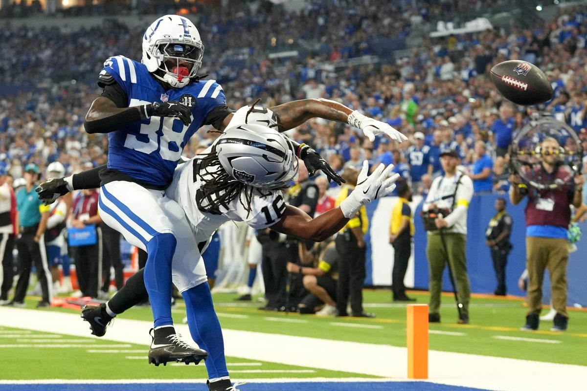 Indianapolis Colts cornerback Chris Lammons (38) takes down Las Vegas Raiders wide receiver Jakobi Meyers (16) as he misses a pass in the end zone Sunday, Oct. 5, 2025, during a game at Lucas Oil Stadium in Indianapolis. The Colts defeated the Raiders 40-6.