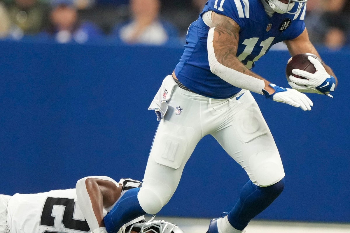 Las Vegas Raiders safety Isaiah Pola-Mao (20) attempts to bring down Indianapolis Colts wide receiver Michael Pittman Jr. (11) on Sunday, Oct. 5, 2025, during a game at Lucas Oil Stadium in Indianapolis. The Colts defeated the Raiders 40-6.