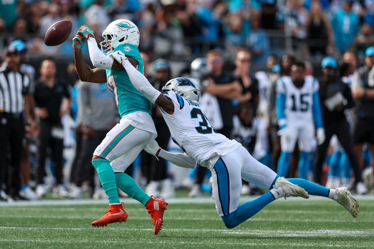 Oct 5, 2025; Charlotte, North Carolina, USA; Miami Dolphins wide receiver Jaylen Waddle (17) misses a catch during the fourth quarter with Carolina Panthers cornerback Corey Thornton (31) defending at Bank of America Stadium. Mandatory Credit: Cory Knowlton-Imagn Images