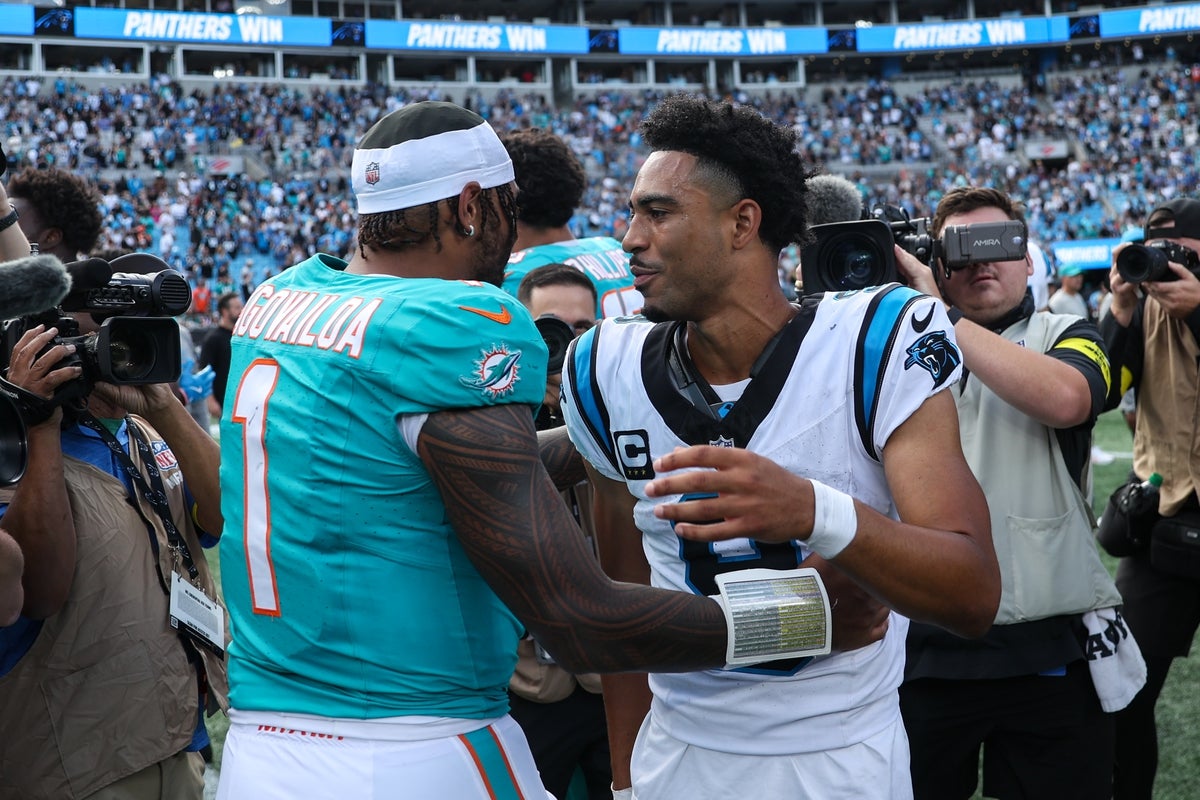 Oct 5, 2025; Charlotte, North Carolina, USA; Carolina Panthers quarterback Bryce Young (9) shakes hands with Miami Dolphins quarterback Tua Tagovailoa (1) following the game at Bank of America Stadium. Mandatory Credit: Cory Knowlton-Imagn Images