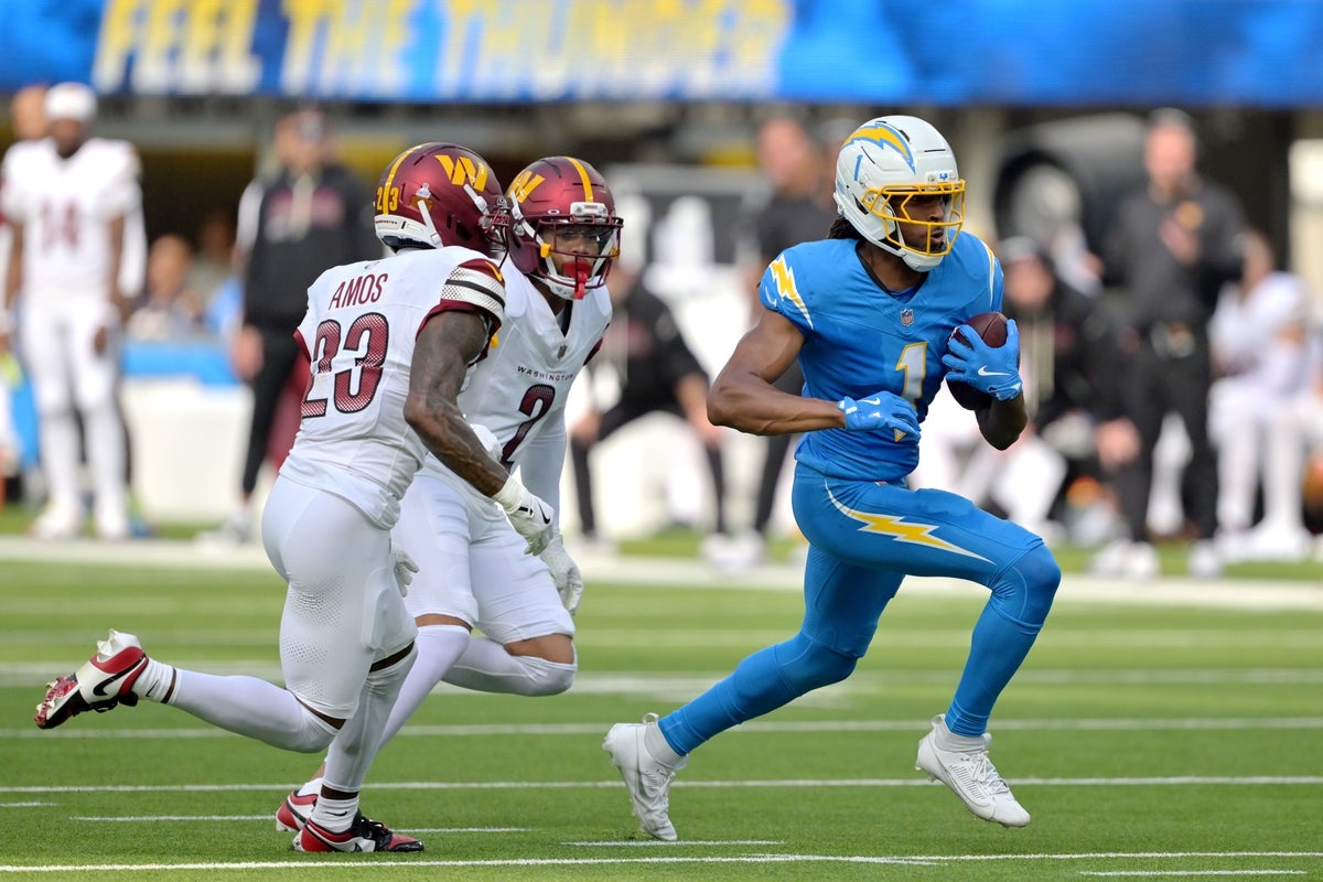 Oct 5, 2025; Inglewood, California, USA; Los Angeles Chargers wide receiver Quentin Johnston (1) runs against Washington Commanders cornerback Trey Amos (23) in the first half at SoFi Stadium. Mandatory Credit: Jayne Kamin-Oncea-Imagn Images