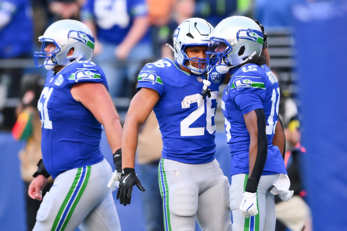 Oct 5, 2025; Seattle, Washington, USA; Seattle Seahawks wide receiver Tory Horton (15) is congratulated by running back Zach Charbonnet (26) after catching a touchdown pass against the Tampa Bay Buccaneers during the second half at Lumen Field. Mandatory Credit: Steven Bisig-Imagn Images