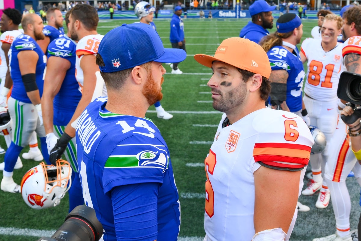 Oct 5, 2025; Seattle, Washington, USA; Seattle Seahawks quarterback Sam Darnold (14) and Tampa Bay Buccaneers quarterback Baker Mayfield (6) meet on the field following a game at Lumen Field. Mandatory Credit: Steven Bisig-Imagn Images