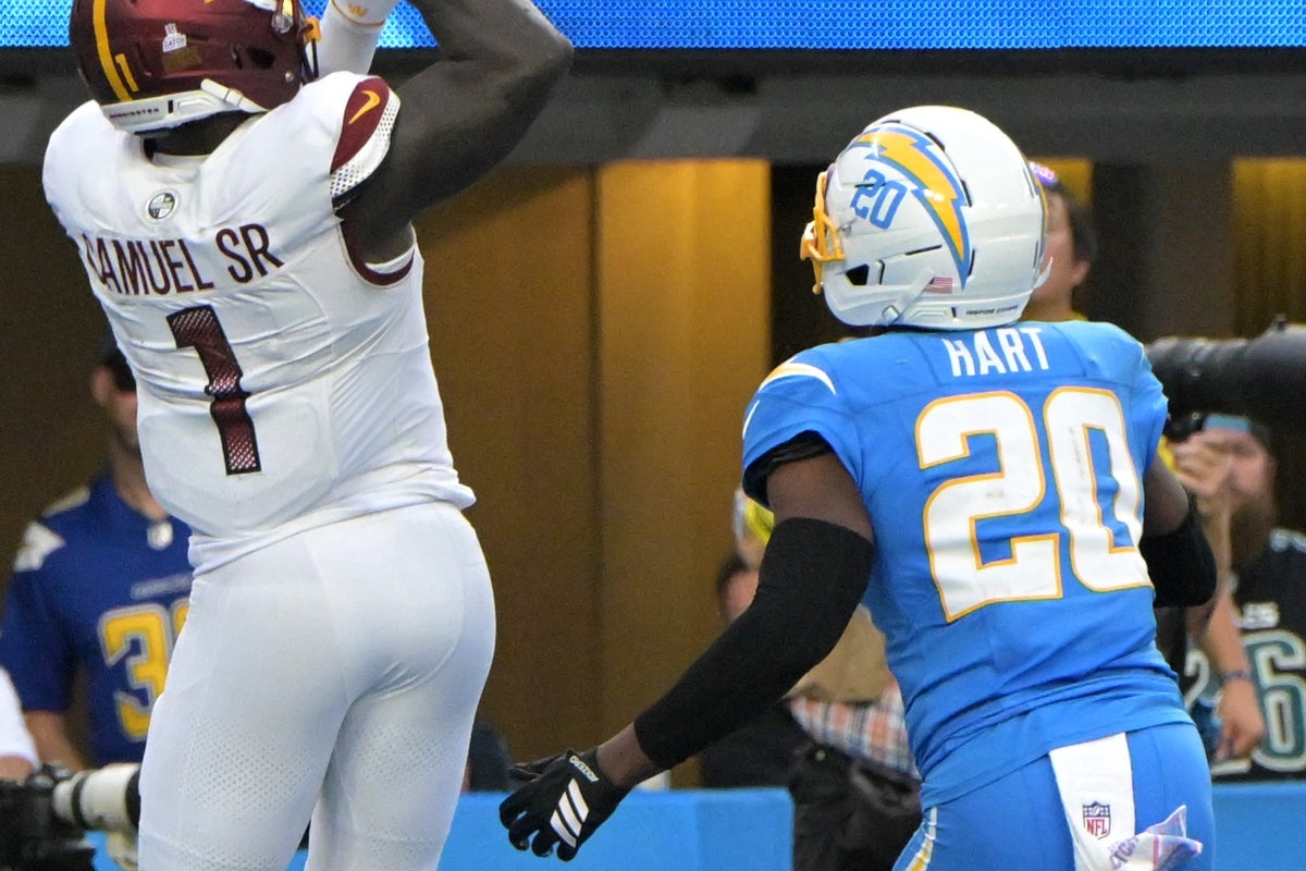 Oct 5, 2025; Inglewood, California, USA; Washington Commanders wide receiver Deebo Samuel Sr. (1) gets past Los Angeles Chargers cornerback Cam Hart (20) for touchdown during the second half at SoFi Stadium. Mandatory Credit: Jayne Kamin-Oncea-Imagn Images