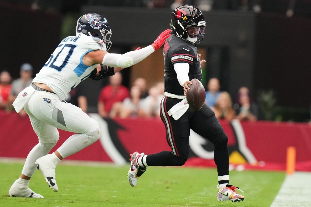 Arizona Cardinals quarterback Kyler Murray (1) scrambles for a first down as Tennessee Titans linebacker Cody Barton (50) closes in at State Farm Stadium in Glendale on Oct. 5, 2025.