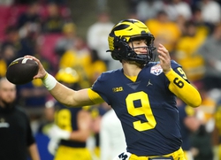 December 31, 2022; Glendale, Ariz; USA; Michigan quarterback JJ McCarthy (9) throws a pass during the pregame before the Fiesta Bowl at State Farm Stadium.  Ncaa Fiesta Bowl Game